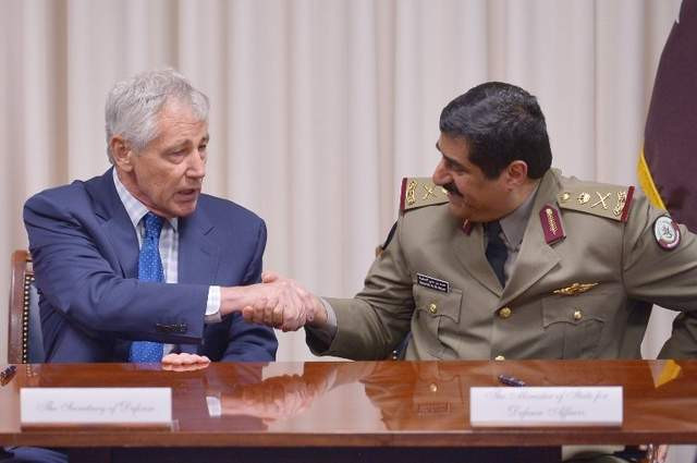Bộ trưởng Quốc phòng Mỹ Chuck Hagel bắt tay với Bộ trưởng Quốc phòng Quatar Hamad bin Ali al-Atiyah sau lễ kí hợp đồng vũ khí hôm 14/7 tại Lầu Năm Góc, Washington, D.C. (Mandel Ngan / AFP)