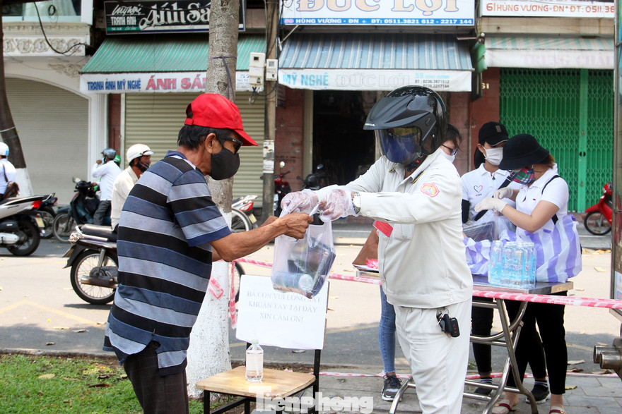 Mỗi ngày, hàng trăm suất cơm miễn phí được phát tại những địa điểm công cộng để “dìu” những hoàn cảnh khó khăn vượt qua bão dịch
