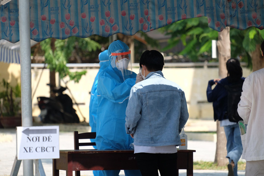 Đo thân nhiệt cho thí sinh trước khi vào các điểm thi làm thủ tục đăng ký dự thi. 