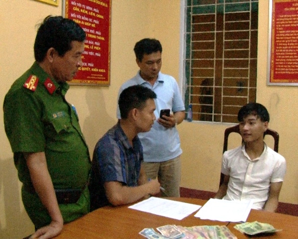 Kẻ cướp táo tợn giữa ban ngày Trần Văn Huy (bìa phải) tại cơ quan công an