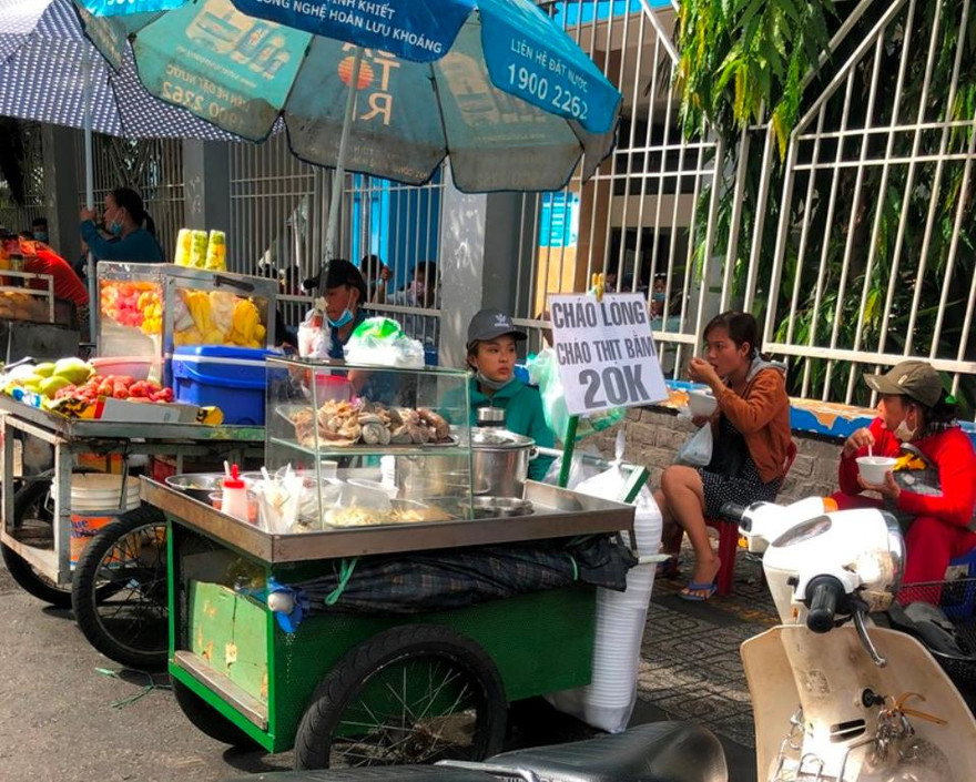 Người kinh doanh hàng rong không đeo khẩu trang, bán hàng cho khách ngay cạnh bệnh viện