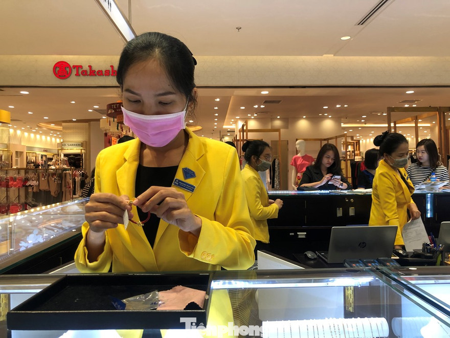 Một nhân viên đeo khẩu trang tiếp khách