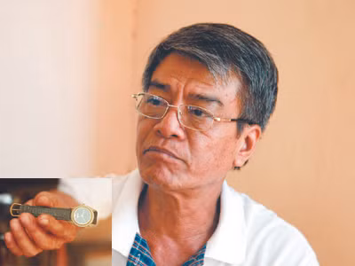 Ông Bùi Minh Hải (ảnh lớn), chiếc đồng hồ oan nghiệt (ảnh nhỏ)
