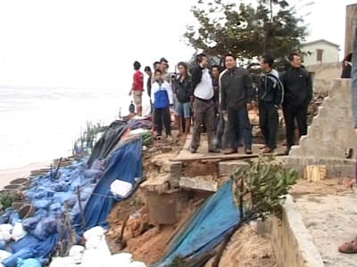 Bao cát và cọc tre không thể chặn sóng dữ. Ảnh: H.N