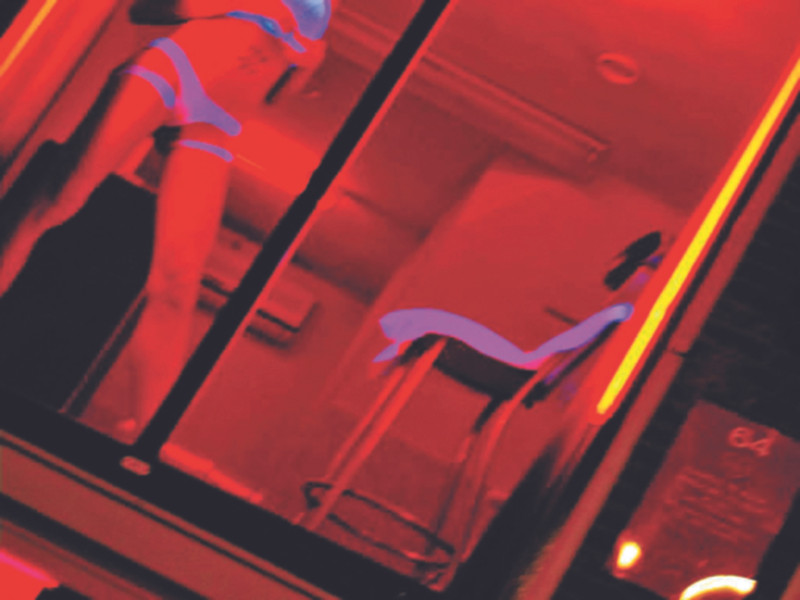 Cô gái trong khung cửa ở khu đèn đỏ đang chờ khách