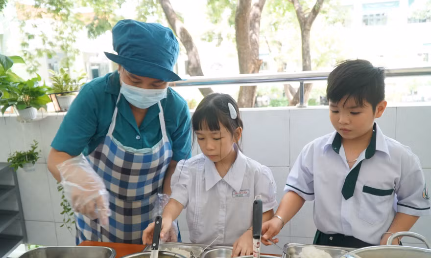 Theo bà Nguyễn Thị Minh Nguyệt, Hiệu trưởng Trường Tiểu học Hiệp Tân, sau sáp nhập, quy mô trường lớn hơn, lại có hai điểm trường nên phương án tổ chức bếp ăn cũng được điều chỉnh. Thay vì tự thực hiện các khâu từ mua thực phẩm đến chế biến như trước, trường thuê một đơn vị bên ngoài đảm nhận hoạt động bếp.