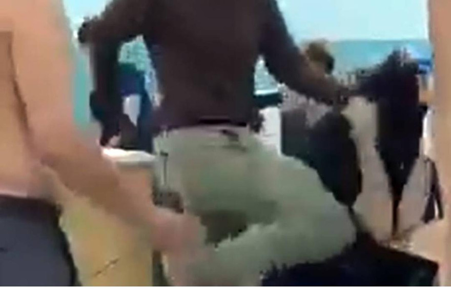 Người đàn ông mặc đồng phục dân phòng liên tiếp đá, đấm vào mặt thiếu niên 14 tuổi, đêm 31/3. Ảnh: Cắt từ video.