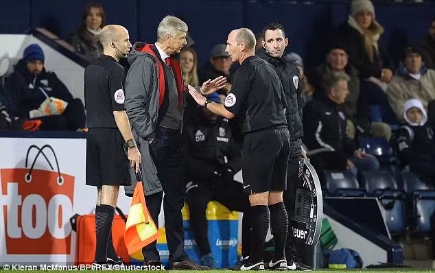HLV Wenger tranh cãi với trọng tài Mike Dean.