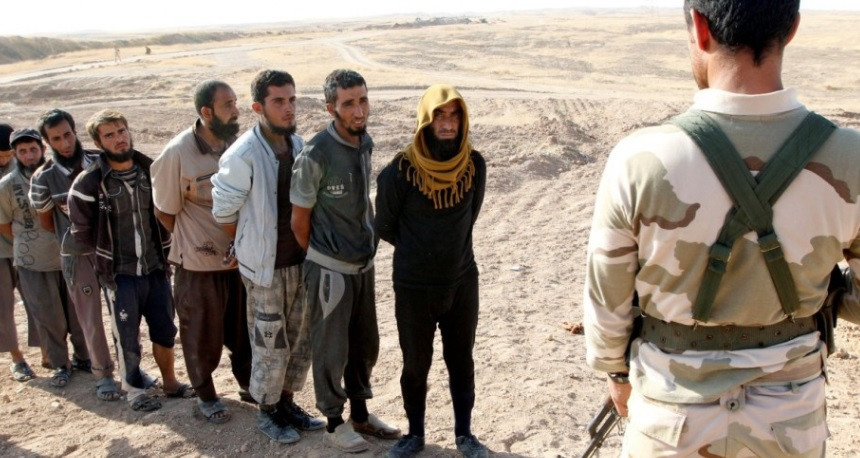 Các chiến binh IS xếp hàng đầu thú. Ảnh: RT