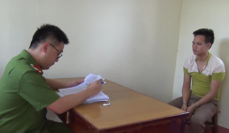 Đối tượng Hoàn (bìa phải) tại cơ quan công an .Ảnh: Minh Anh