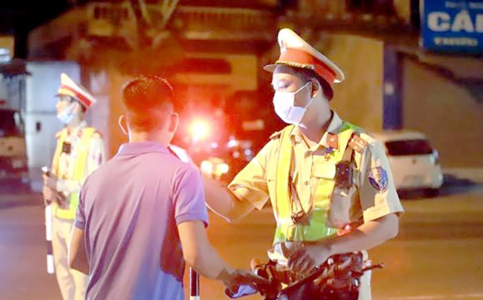 Lực lượng cảnh sát giao thông kiểm tra nồng độ cồn của tài xế trong ngày đầu ra quân đảm bảo trật tự an toàn giao thông dịp Lễ 30/4-1/5/2021. Ảnh: CSGT.