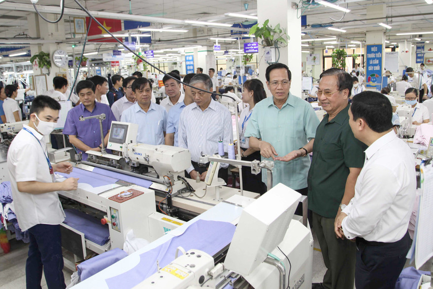 Bộ trưởng Đào Ngọc Dung (áo xanh) trực tiếp khảo sát điều kiện làm việc của công nhân may, và lắng nghe ý kiến của DN về Dự thảo Bộ Luật Lao động sửa đổi.