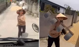 Phơi lúa lấn đường, người phụ nữ dùng cào chặn xe tải, tấn công tài xế 