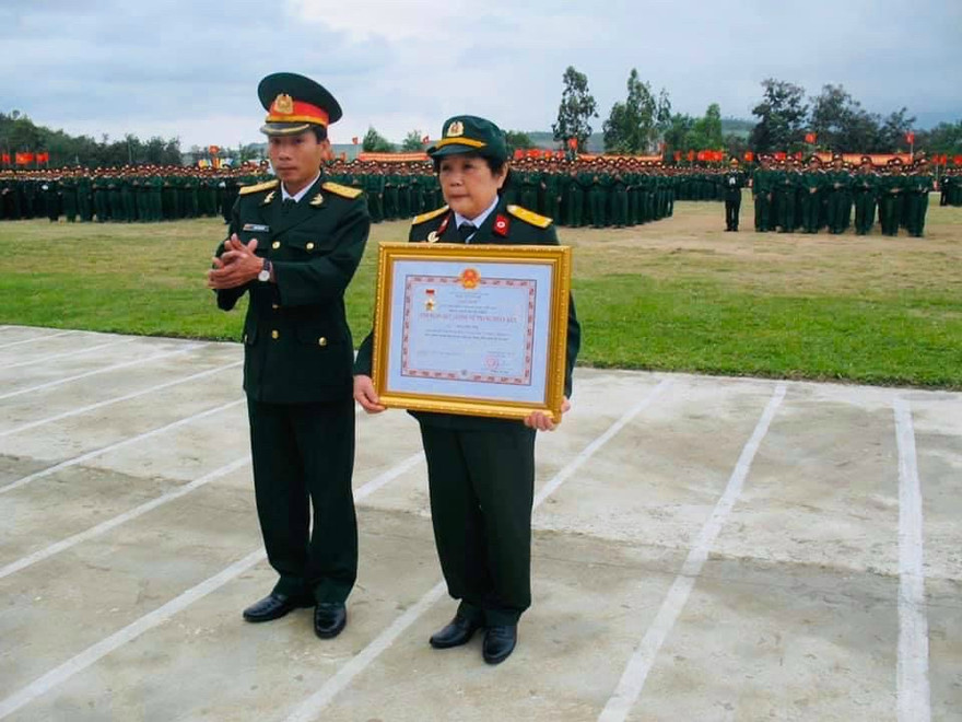 Bà Nguyễn Thị Vân, vợ Bác sỹ Đặng HữuTuệ thay mặt chồng nhận Quyết định truy tặng của Chủ tịch nước