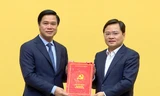 Bí thư tỉnh Bắc Ninh Nguyễn Anh Tuấn (bên phải) trao quyết định cho ông Lê Xuân Lợi.