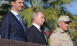 Tổng thống Nga Vladimir Putin (giữa) gặp người đồng cấp Syria Assad (trái) khi đến thăm căn cứ Khmeimim. Ảnh: Sputnik.