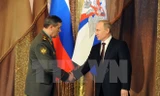 Tổng thống Putin (phải) và Tướng Valery Gerasimov trong cuộc họp với các tướng lĩnh đứng đầu quân đội Nga tại Moskva. (Nguồn: AFP/TTXVN)