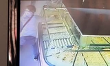 Tên cướp dùng búa đập tủ kính lấy vàng trong 5 giây. Ảnh chụp lại từ màn hình camera.