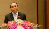 Phó Thủ tướng Nguyễn Xuân Phúc thay mặt Chính phủ báo cáo Quốc hội về tình hình kinh tế xã hội năm 2015. Ảnh: Quochoi.vn.