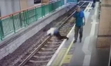 Video sốc: Người đàn ông đẩy ngã nữ lao công xuống đường ray