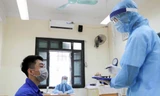 12 tình huống thí sinh nghi mắc COVID-19, nhân viên y tế hướng dẫn thí sinh mặc đồ bảo hộ