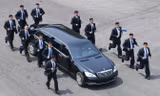 12 vệ sĩ chạy bộ quanh xe bọc thép của lãnh đạo Triều Tiên Kim Jong-un