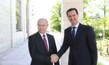 Tổng thống Nga Putin bắt tay Tổng thống Syria Assad. Ảnh: Sputnik