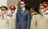 Tổng thống Syria Bashar al-Assad (áo đen). Ảnh: Sputnik
