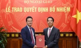 Thứ trưởng Tô Anh Dũng trao quyết định cho tân Vụ trưởng Vụ Ngoại giao văn hóa và UNESCO Mai Phan Dũng.