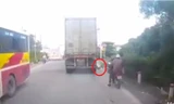 Người đàn ông bỏ xe máy bên đường, lao vào gầm container tự sát. Ảnh cắt từ video