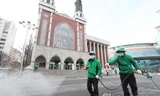 Nhân viên vệ sinh khử trùng khu vực bên ngoài một nhà thờ ở Seoul. Ảnh: Yonhap