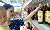 Người tiêu dùng lựa chọn nước mắm Phú Quốc tại siêu thị Fivimart (Hà Nội). Ảnh: Như Ý.