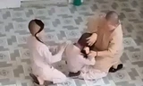 Hình ảnh ghi lại cảnh sư cô liên tục đánh vào mặt tiểu ni. (Ảnh cắt từ clip)