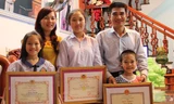 Gia đình anh Thành, chị Yến với những tấm giấy khen của Công an tỉnh Bắc Giang.