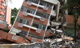 Tòa nhà bị bật móng và nghiêng hẳn sang một bên sau tiếng động lớn.