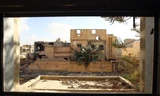 Một tòa nhà bị hư hại trong giao tranh ở thành phố Benghazi, Libya. Ảnh: AFP.