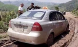 Chiếc xe taxi được tìm thấy ở đoạn đường vắng, sình lầy. Ảnh: TL