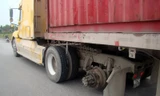 Chiếc xe container bị rơi bánh phía sau đầu kéo được đưa về cơ quan công an.