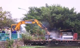 Máy múc được đưa vào để phá dỡ nhà nổi.