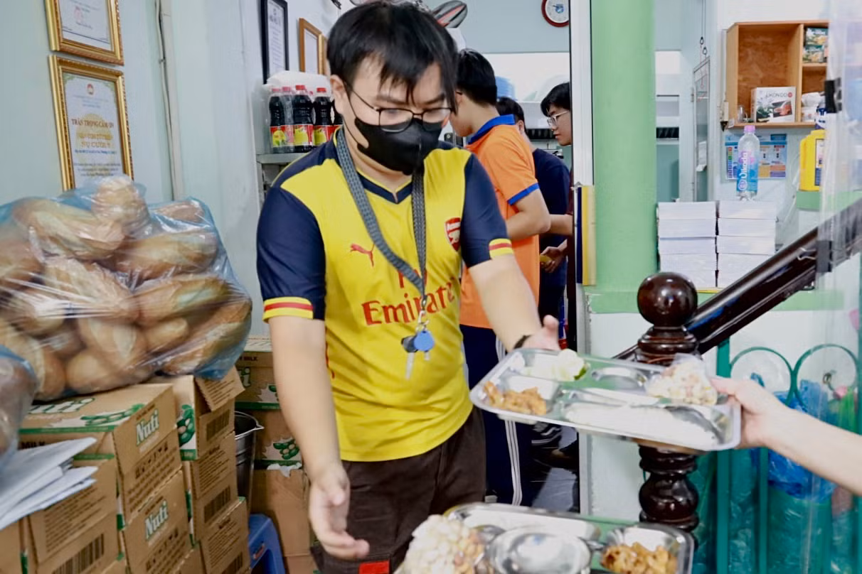 Anh Trương Huỳnh Trung Kiên phụ giúp quán chuyền cơm từ phòng bếp ra bàn ăn. (Ảnh: Thùy Trân) Anh Trương Huỳnh Trung Kiên phụ giúp quán chuyền cơm từ phòng bếp ra bàn ăn. (Ảnh: Thùy Trân)