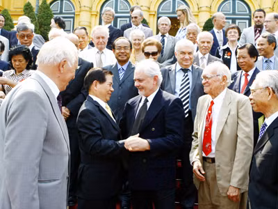 Chủ tịch nước Nguyễn Minh Triết bắt tay ông Burchett Goergre (Úc) tại buổi gặp gỡ bạn bè quốc tế 