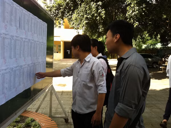 Sĩ tử xem số báo danh, phòng thi của mình tại hội đồng thi trường THPT Phạm Hồng Thái (Hà Nội)