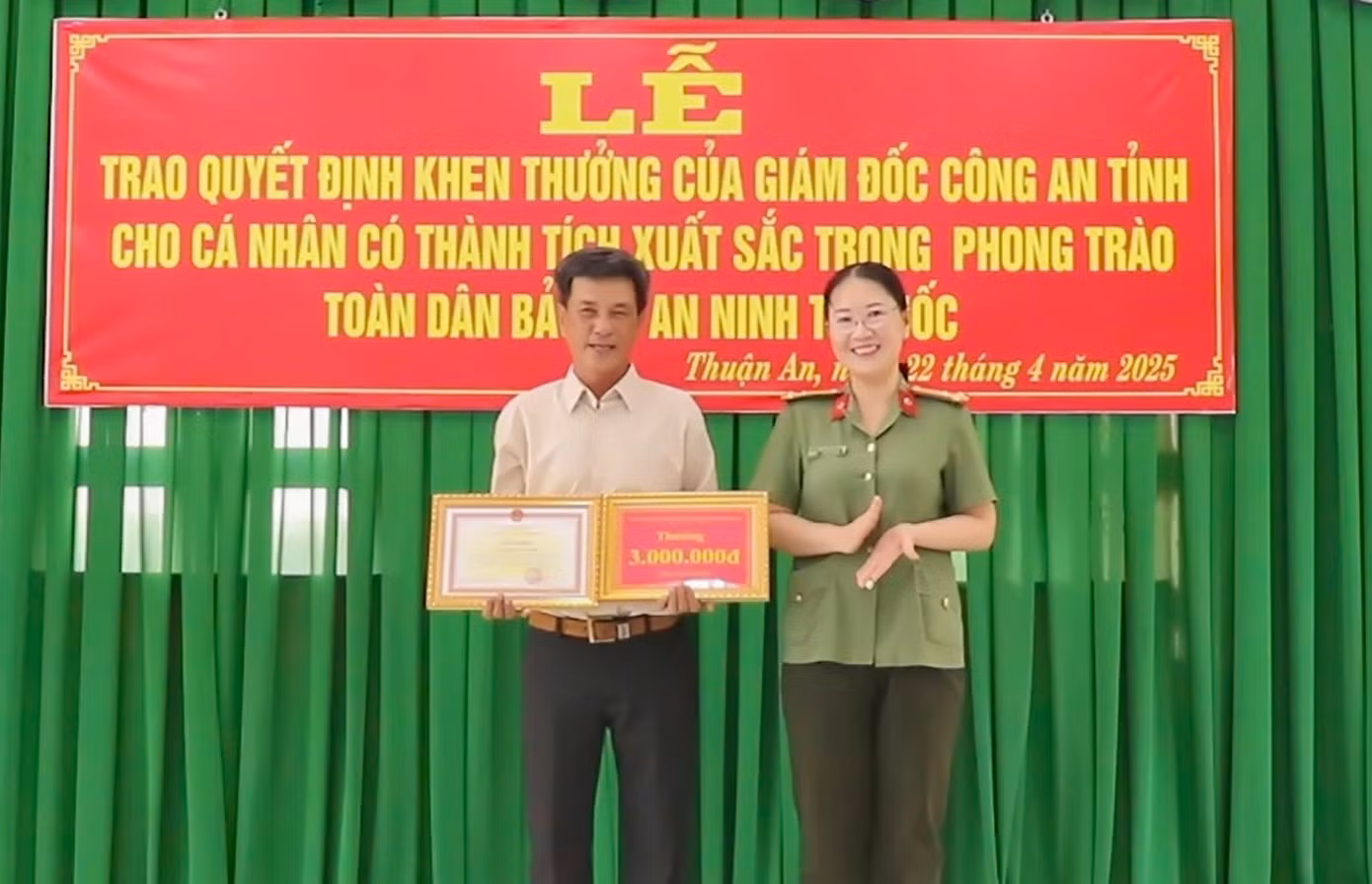 Thượng tá Nguyễn Thị Hải Yến - Phó Giám đốc Công an tỉnh Vĩnh Long trao giấy khen cho ông Trần Văn Nhất.