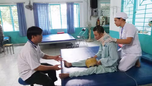Một điều dưỡng đang tập vật lý trị liệu cho bệnh nhân tại Bệnh viện Điều dưỡng - Phục hồi chức năng - Điều trị bệnh nghề ngiệp