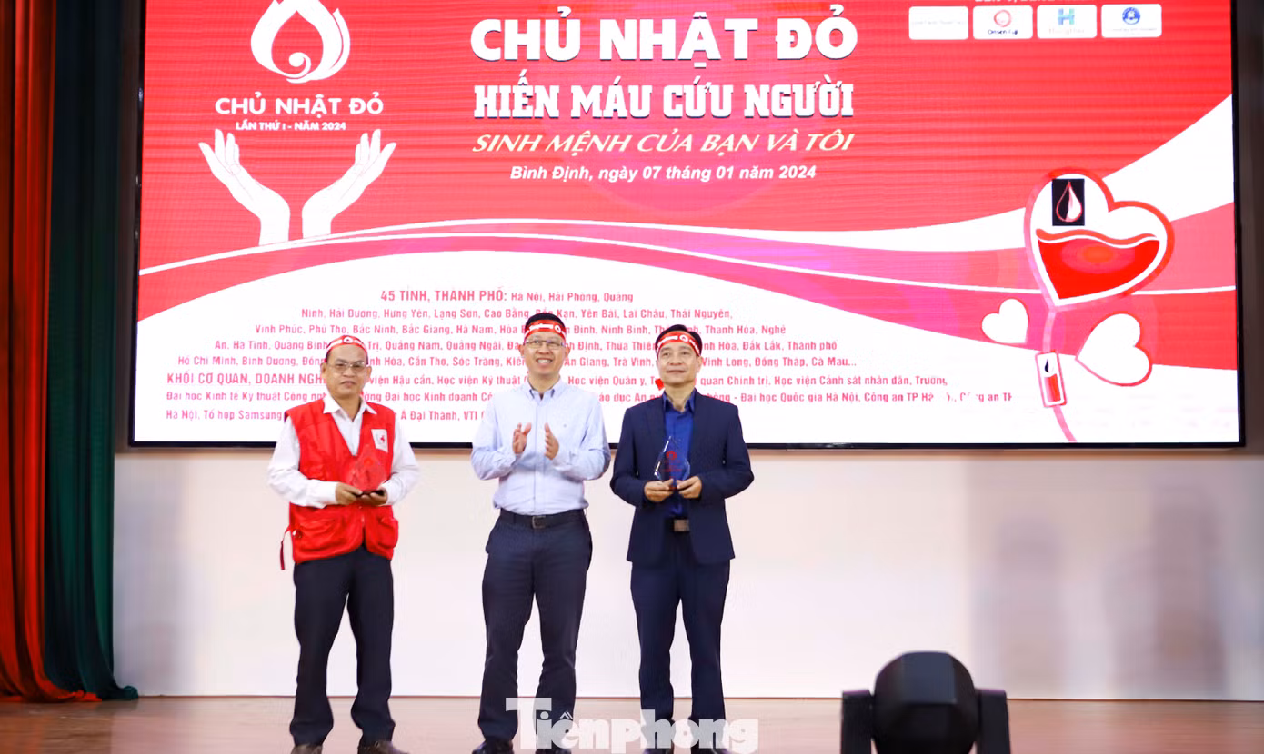 Nhà báo Lê Minh Tuấn - báo Tiền Phong (ở giữa) trao kỷ niệm chương cho đơn vị phối hợp chương trình Chủ Nhật Đỏ tỉnh Bình Định lần thứ I – năm 2024. Ảnh: Trương Định