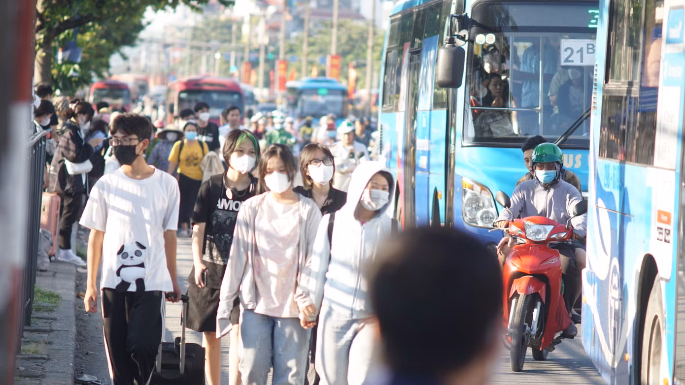 Tại khu vực bến xe Giáp Bát, nhiều người dân đi bộ phải tràn xuống lòng đường để di chuyển khiến các phương tiện phải đi chậm.