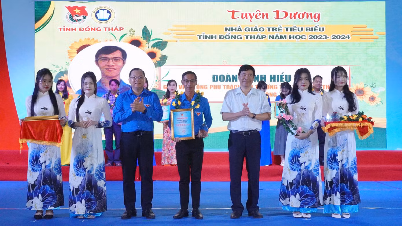 Ông Phạm Thiện Nghĩa (áo trắng) - Chủ tịch UBND tỉnh Đồng Tháp và anh Huỳnh Minh Thức - Bí thư Tỉnh Đoàn Đồng Tháp tuyên dương nhà giáo trẻ tiêu biểu.