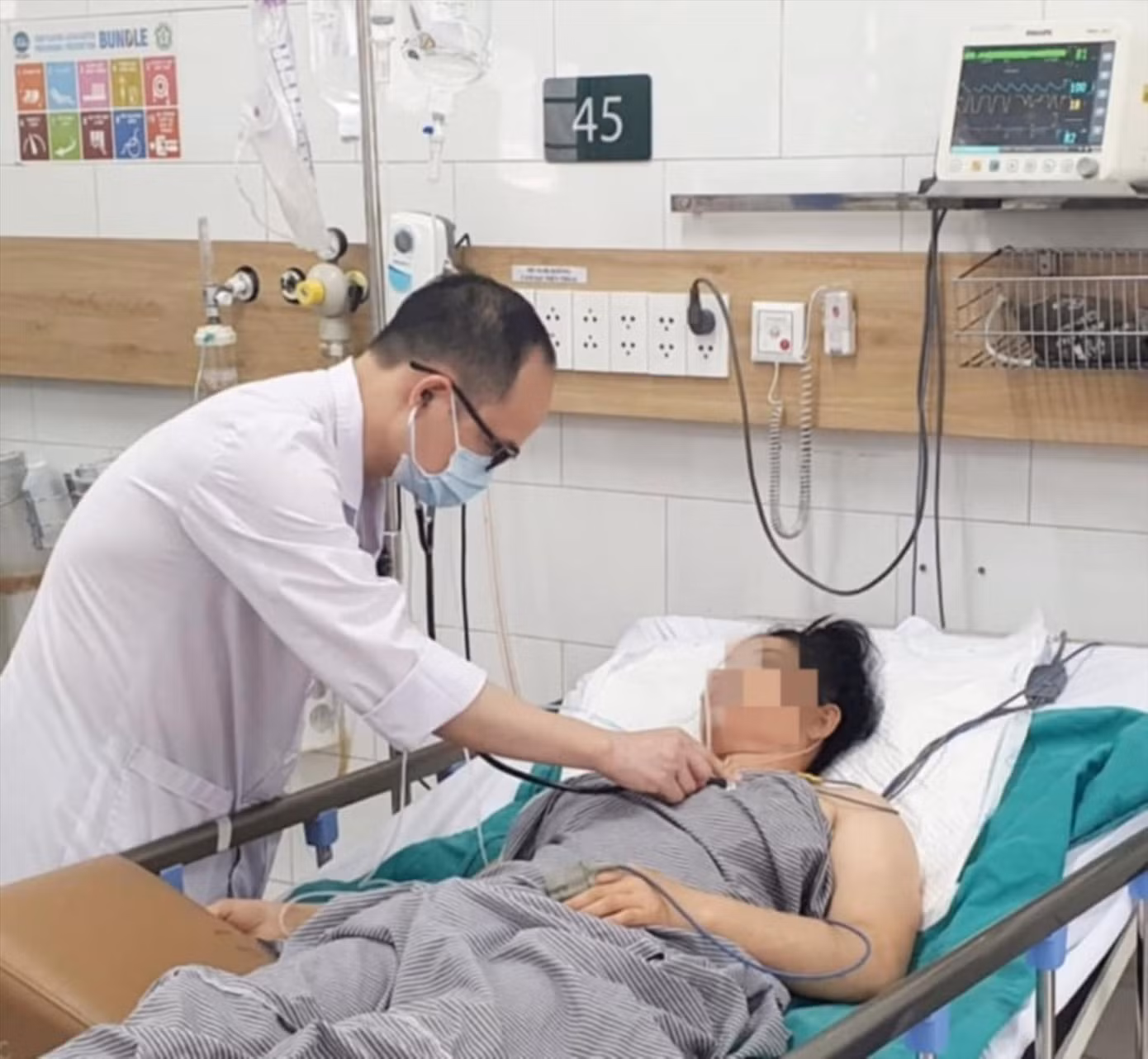 Bác sĩ khám cho người mẹ trong gia đình có 3 người hôn mê vì khí CO.