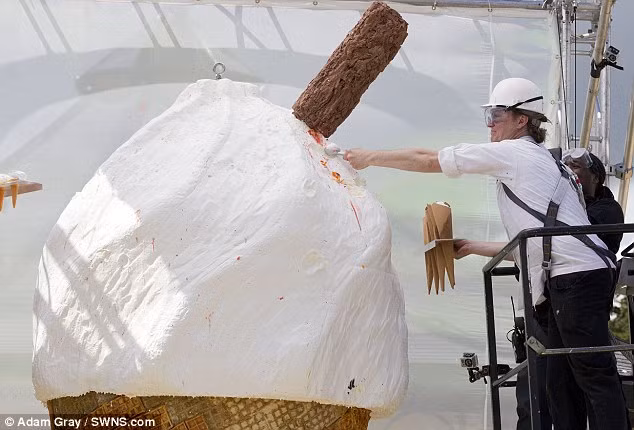 Các công nhân đang múc kem chia thành những ly nhỏ ể phát cho mọi người cùng thưởng thức.