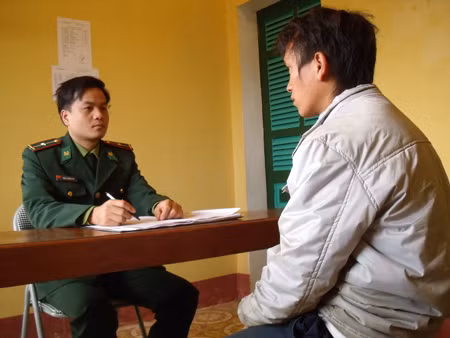  Cán bộ biên phòng đang lấy lời khai một đối tượng tổ chức đưa người khác trốn ra nước ngoài